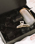 Black bridesmaid proposal gift box with black satin robe, travel jewelry box, glass tumbler with bamboo lid and gold straw, pearl hair claw and heart sunglasses. handmade by bossy creations