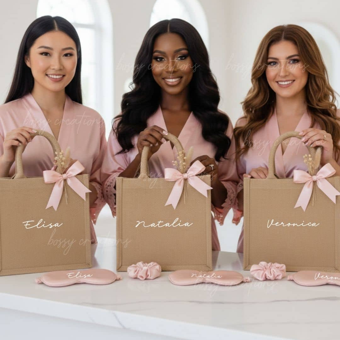 Three women holding personalized bags with names on them, wearing matching robes.