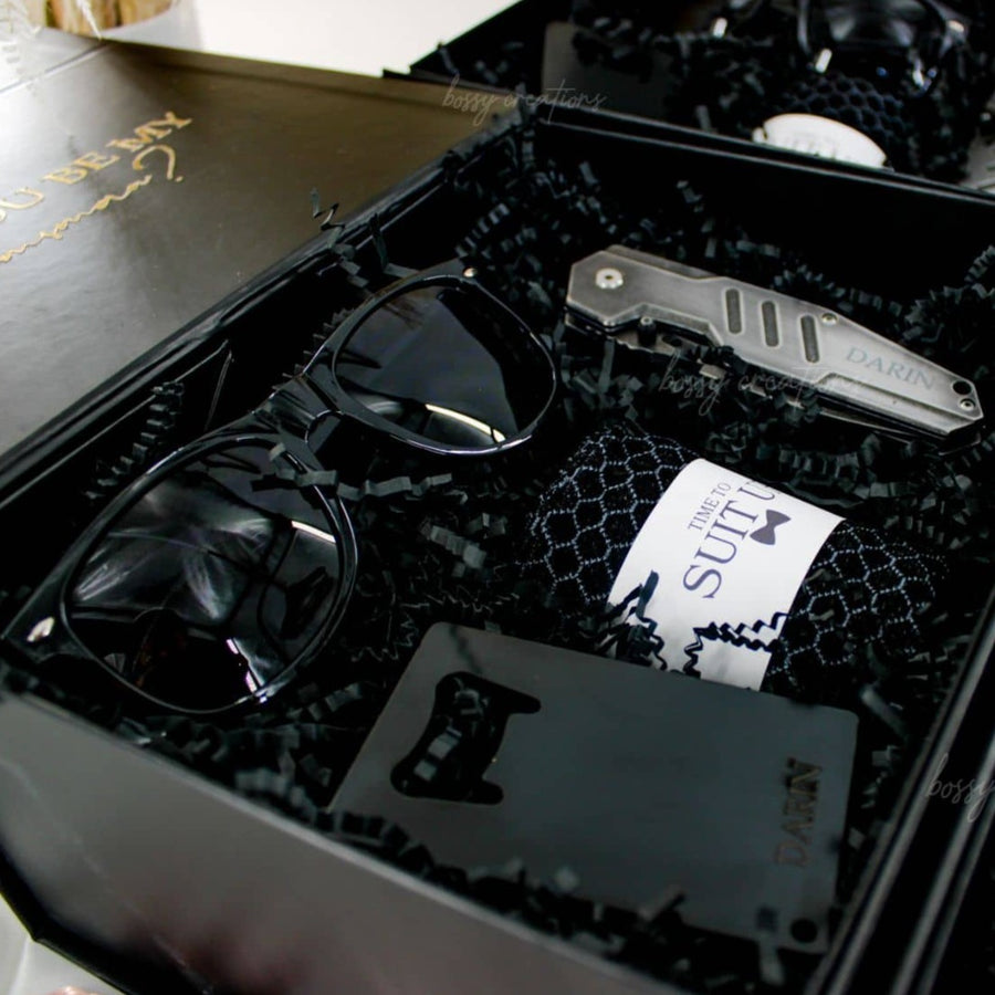 Groomsmen & Best Man Black Proposal Gift Boxes. Engraved pocket knife, engraved bottle opener, socks, and sunglasses. handmade by bossy creations