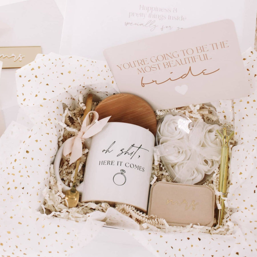 Happy Engagement gift box for bride with funny ceramic mug, wooden coaster lid and gold spoon. velvet mrs ring box, gold diamond pen, and rose petal scented soap. handmade by bossy creations