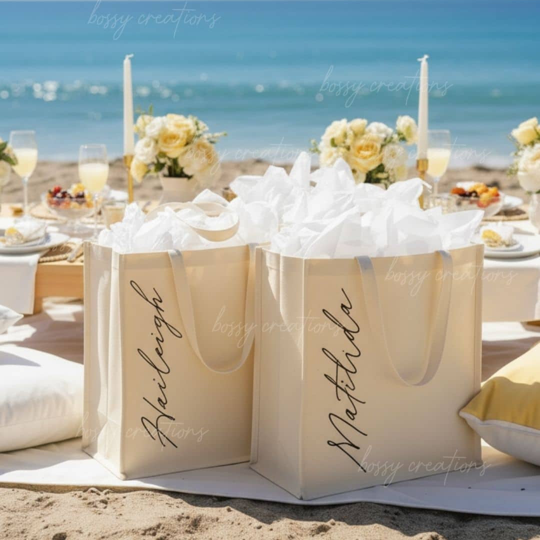 Beachside bridesmaid picnic in pale yellow color theme table setting with personalized gift bags, flowers, and candles by the ocean.